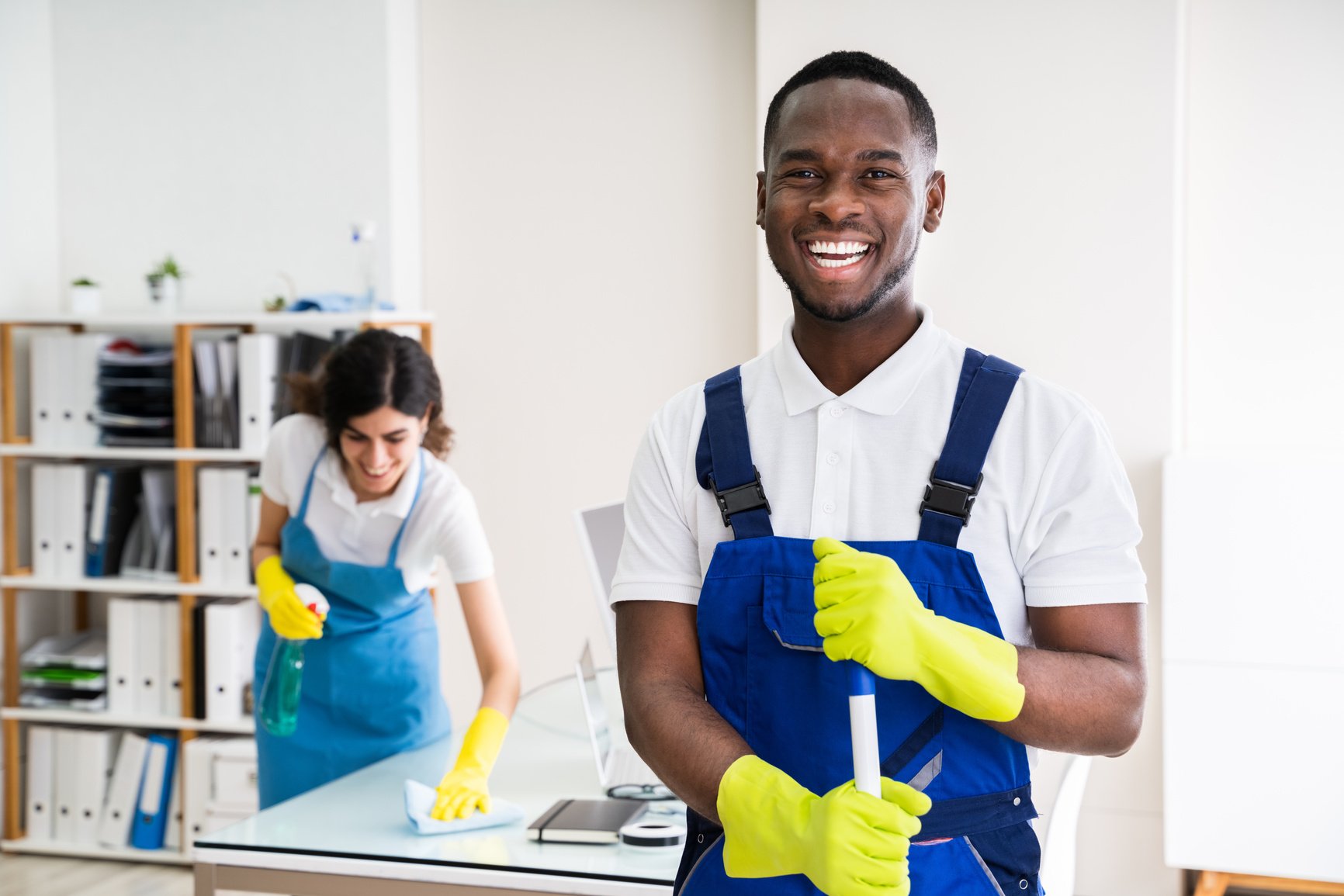 Happy Male Janitor In Office