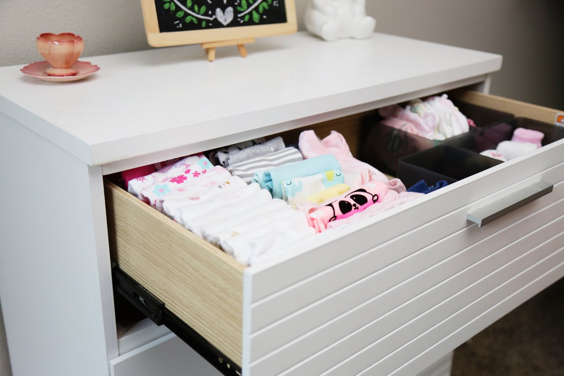 Baby Girl clothing folded neatly in dresser drawer