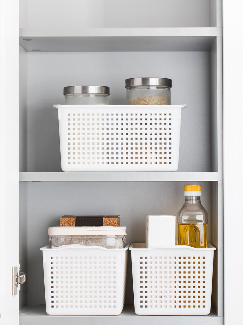 Storage of dry food in plastic containers in the kitchen cabinet. Organization of storage.